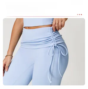 Detail of light blue high waisted yoga pants with side ruched drawstring design