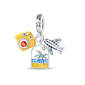 Detailed view of silver charm bead featuring airplane, camera and beach pendants