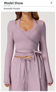 Detail view of lavender purple yoga top with tie-waist cross strap and long sleeves