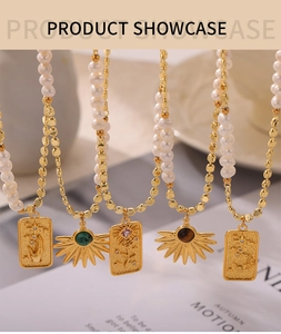 Close-up of golden necklaces with freshwater pearls and diverse vintage tarot pendants