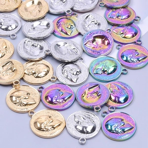 Macro view of detailed skull coin pendants in gold, silver, and iridescent finishes