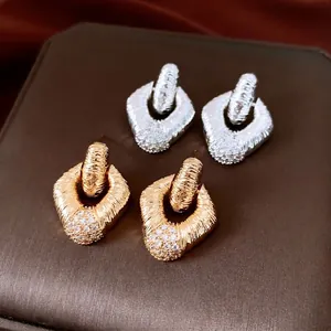 Luxury geometric rhomboid earrings set with gold and silver finish and diamond inlay