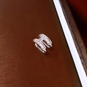 Macro detail of H-shaped ear cuff featuring channel-set rectangular baguette zircons