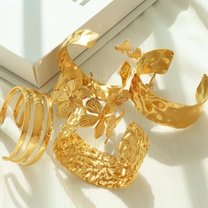 Adjustable gold titanium steel wide bangles with hammered texture and floral accents