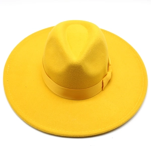 Detailed top view of bright yellow wool fedora hat showing wide brim and satin band