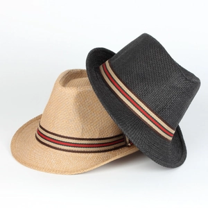Detail of black and beige woven straw fedoras with striped bands on white backdrop