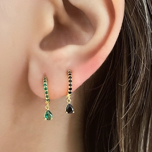 Detail of drop-shaped earrings with pave-set zircons in green and black crystals