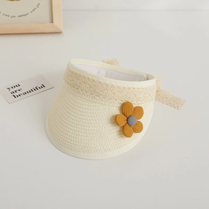 Detail of straw sun visor for kids with lace trim and a yellow fabric flower accent