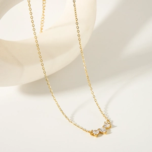 Elegant gold-tone stainless steel necklace featuring three sparkling heart-shaped zircons