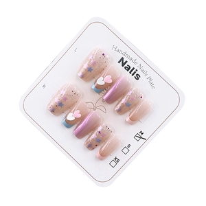 Sparkly pink handmade press-on nails with star patterns and 3D heart charms