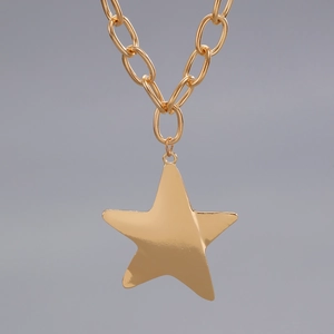 Detailed view of glossy gold alloy star pendant with bold oval link chain necklace