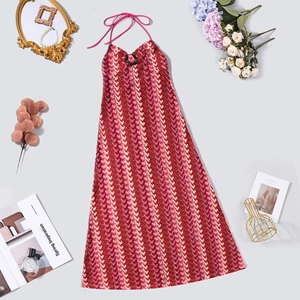 Detailed flat lay of a wavy striped halter knit dress with vintage accessories and flowers