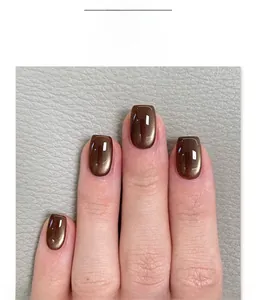 Detail of short square press-on nails in metallic deep coffee cat eye finish