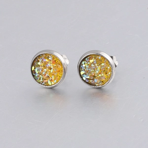 Macro shot of 8mm stainless steel gold glitter studs with silver butterfly backs