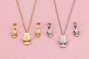 Detailed view of Roman numeral necklaces and earrings set with inlaid diamonds