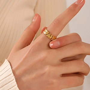 18K gold plated titanium steel leaf ring on model finger with adjustable open design