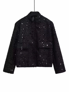 Detail of black sequined tweed texture on short loose fit jacket with dual pockets