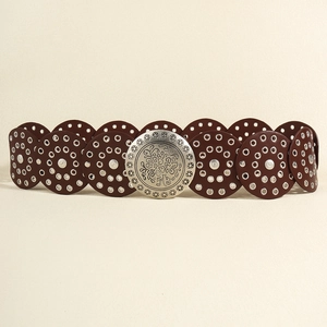 Detailed close-up of dark brown leather circles with silver eyelets and engraved buckle