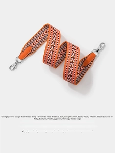 Detail of 3.8cm wide orange waxed canvas strap with leather ends and silver metal clips