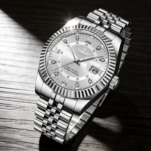Macro view of silver metal watch dial with calendar window and roman numerals
