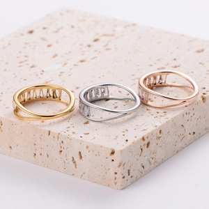 Exquisite gold silver and rose gold rings with baguette zircon on travertine base