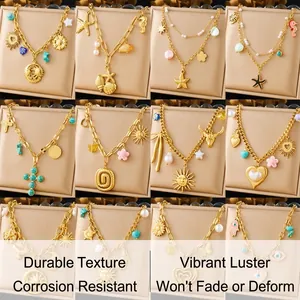 Detail view of 12 gold pendant necklaces with sun, moon, and turquoise bohemian charms