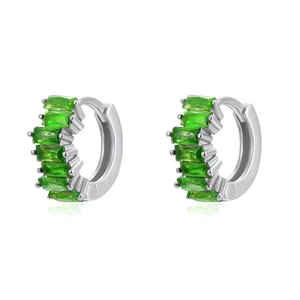 Macro view of silver huggie earrings featuring emerald green rectangular zircons