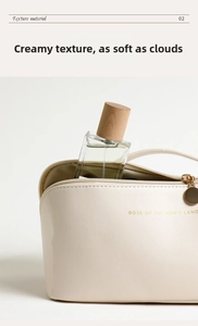 Detailed close-up of cream PU cosmetic bag showing soft texture and gold zipper details