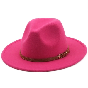 Close-up of rose red wool felt fedora with brown leather belt and golden metal buckle