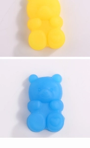 Close-up of cute yellow and blue gummy bear squeeze toys with a frosted resin texture