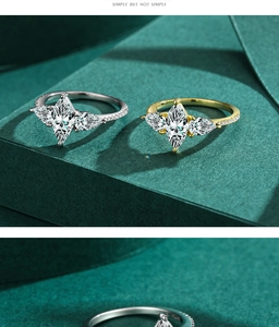 Macro shot of silver and gold S925 rings with marquise cut stones and side accents