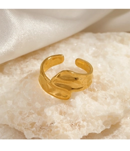 Close-up of 18K gold-plated irregular wave ring on white crystal stone with satin detail