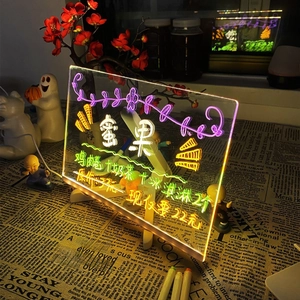 Macro shot of transparent LED message board with RGB glow on a wooden base
