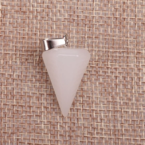 Macro view of a conical pink quartz crystal pendant on rustic burlap fabric background