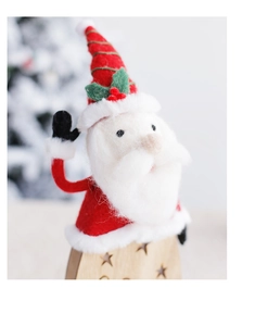 Close-up of wool felt Santa Claus ornament with a star-cutout wooden base and soft textures