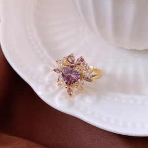 Macro shot of 14k gold-plated floral ring with purple heart gem and marquise zircons