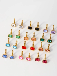 Detailed close-up of gold hoop earrings featuring rectangular multi-colored crystal drops