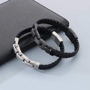 Close-up of braided leather bracelets with stainless steel chain and magnetic buckle