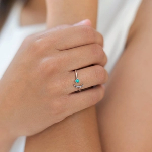 Minimalist 18k gold plated moon ring with turquoise bead on model hand finger