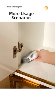 Detail of grey microfiber gap brush cleaning a metal cabinet hinge in narrow spaces