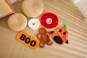 Close-up of Halloween plush cushions set with pumpkin and ginger man on wood floor