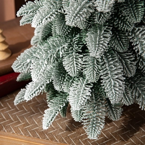 Green 55cm artificial Christmas tree with dense PE leaves and realistic snow flocking