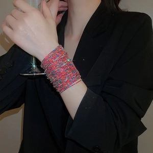 Close-up of stacked elastic bracelet with multi-colored rhinestones on a wrist