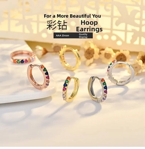Detail showing colorful AAA zircon stones inlaid in gold and silver hoop earrings