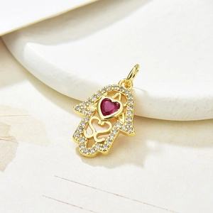 Golden Hamsa necklace pendant with colorful zircons and a red heart gemstone