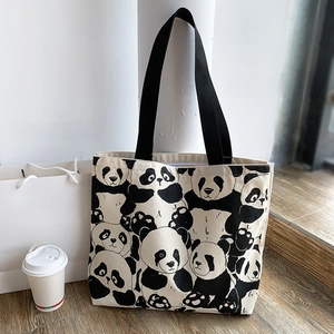 Detail of panda print canvas tote bag showing double-sided design and sturdy shoulder straps