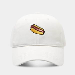Close-up of vibrant hot dog embroidery on a white six-panel cotton baseball cap
