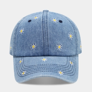 Light blue denim baseball cap with small daisy floral embroidery and a casual style