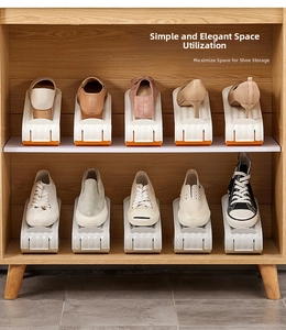 Detail view of adjustable double-layer plastic shoe racks saving space in a wooden cabinet