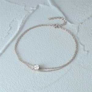 Detail of s925 silver double-layered bracelet with a sparkling cz stone centerpiece